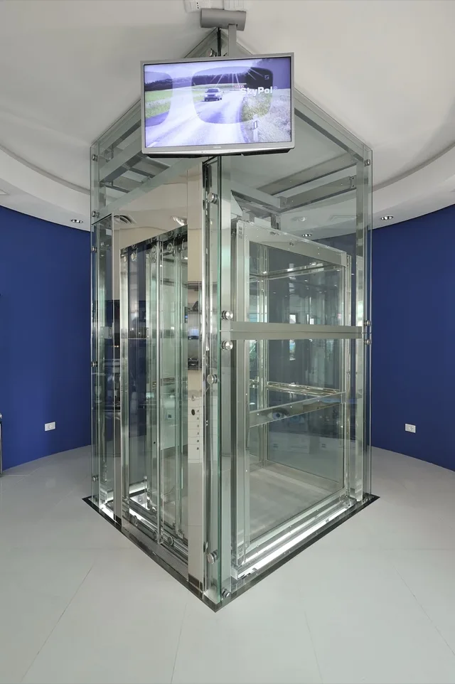 Glass elevator in a room with deep blue walls