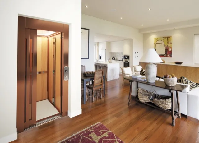 Wood-framed elevator opening onto a living room with a wooden floor
