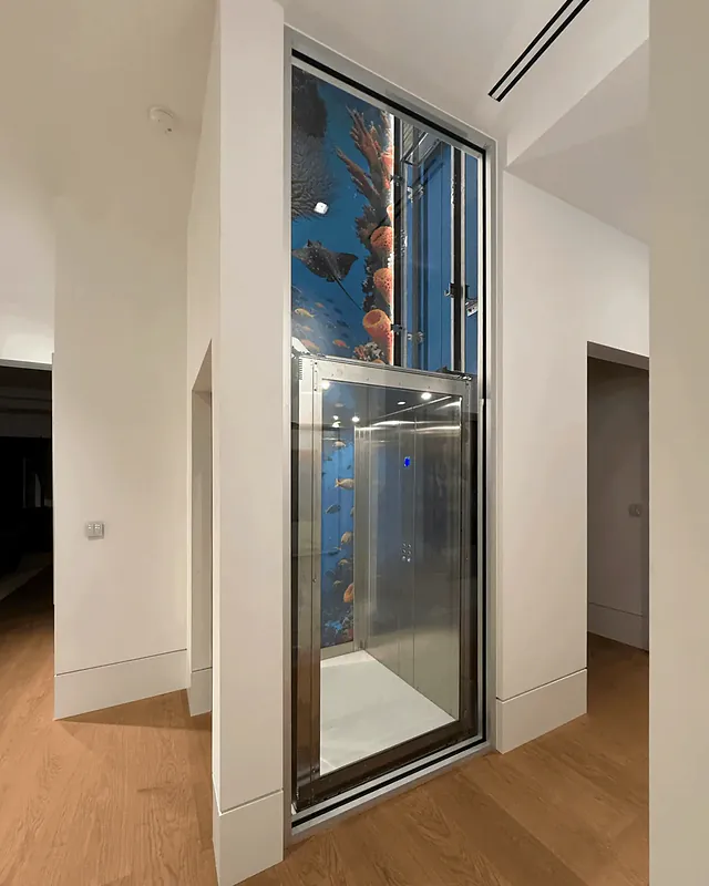 Fully glazed elevator cabin in a glass-fronted shaft