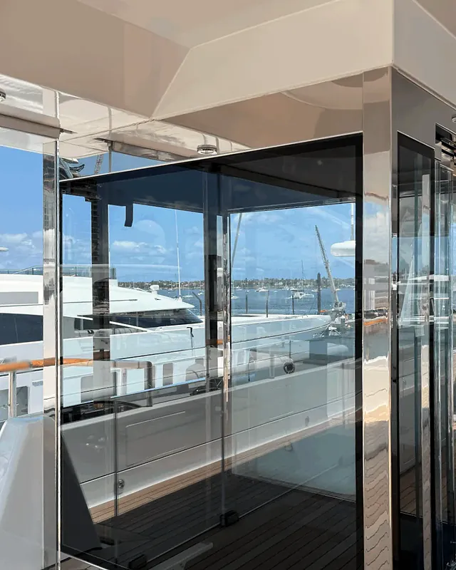 Frameless glass lift enclosure aboard a private yacht